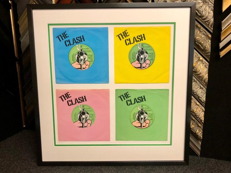 Limited edition print of The Clash, framed with a black satin wood finish.