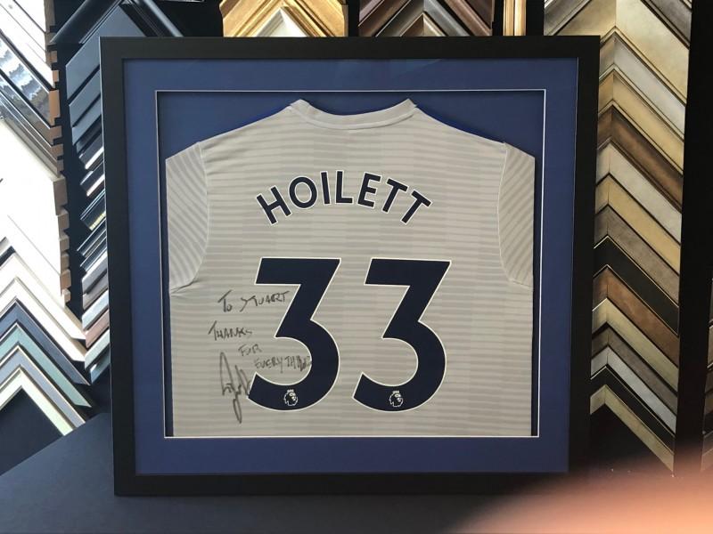 Cardiff City home shirt signed by Junior Hoilett, framed in a black Matt moulding, mounted and glazed with Tru Vue reflection control glass. Cardiff City home shirt signed by Junior Hoilett, framed in a black Matt moulding, mounted and glazed with Tru Vue reflection control glass.
