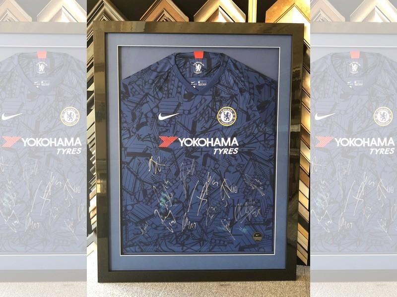Chelsea 2019/2020 season home shirt signed by the team, framed with a gloss black moulding, mounted and glazed with Tru Vue reflection control glass.