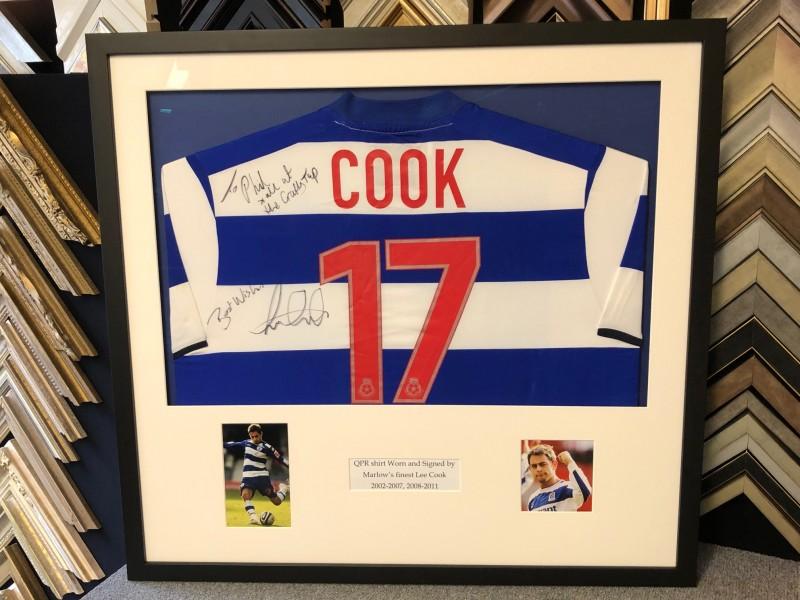 Queens Park Rangers home shirt signed by ex-player Lee Cook, framed with a Matt black moulding, mounted with photos and text inserts, glazed with Tru Vue regards control glass.