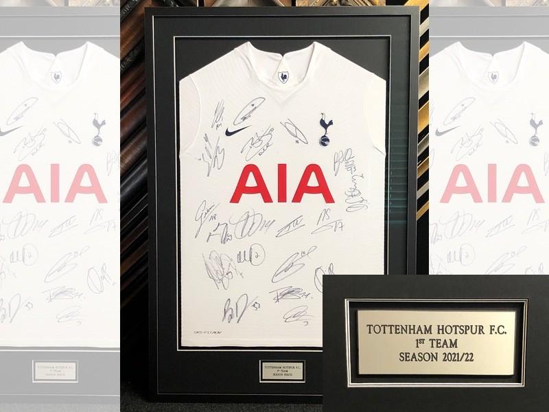 2021/22 Tottenham Hotspur home shirt signed by the current squad, framed with a Matt black moulding with silver edges, the shirt is pinned and mounted with an inscribed plaque mounted in an aperture within the mount.
