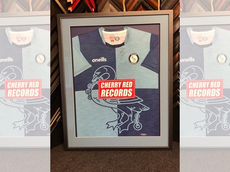 Wycombe Wanderers signed home shirt, framed with a Matt black moulding with silver edges, the shirt is pinned and mounted, and glazed with Tru Vue reflection control glass.