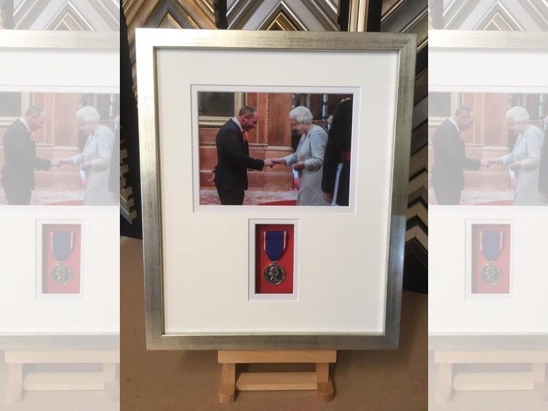 A medal awarded by the Queen for long service to the Crown Estate, framed in a distressed silver box frame, mounted and glazed with Tru Vue reflection control glass.