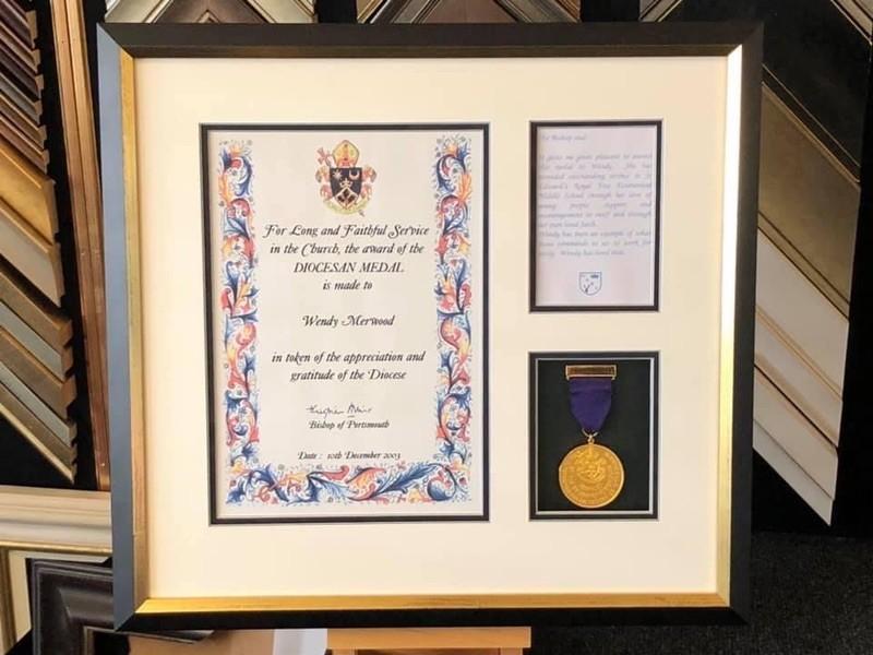 A medal and certificate awarded to St Edwards Royal Free School in Windsor. Framed with a Matt black with gold edge box frame mounted and glazed with Tru Vue reflection coming glass.