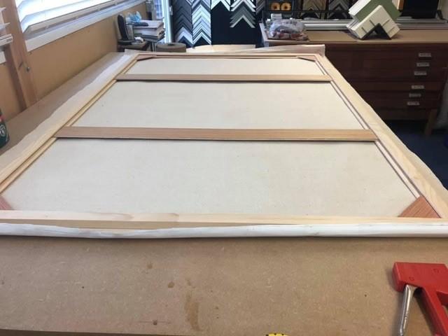 Stretcher frame made and placed onto the back of the canvas to be stretched. Stretcher frame made and placed onto the back of the canvas to be stretched.