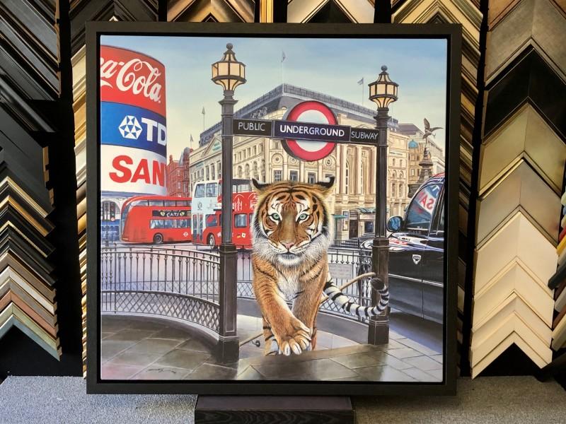 A contemporary oil painting of the London Underground, stretched and float framed with a Matt black tray frame.