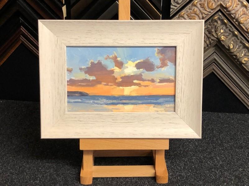 An oil painting on board, framed with a scooped white washed mouldings.