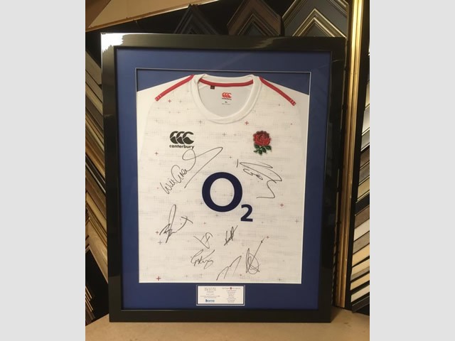 Signed England rugby shirt framed in a black gloss box frame.
